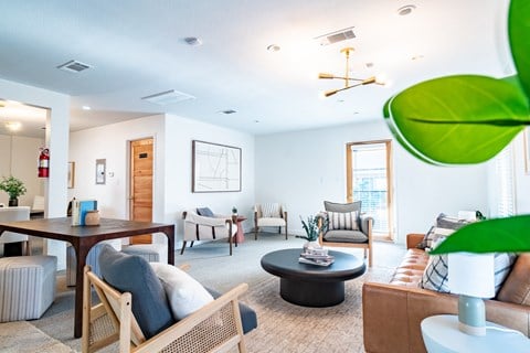 a living room with furniture and a dining table